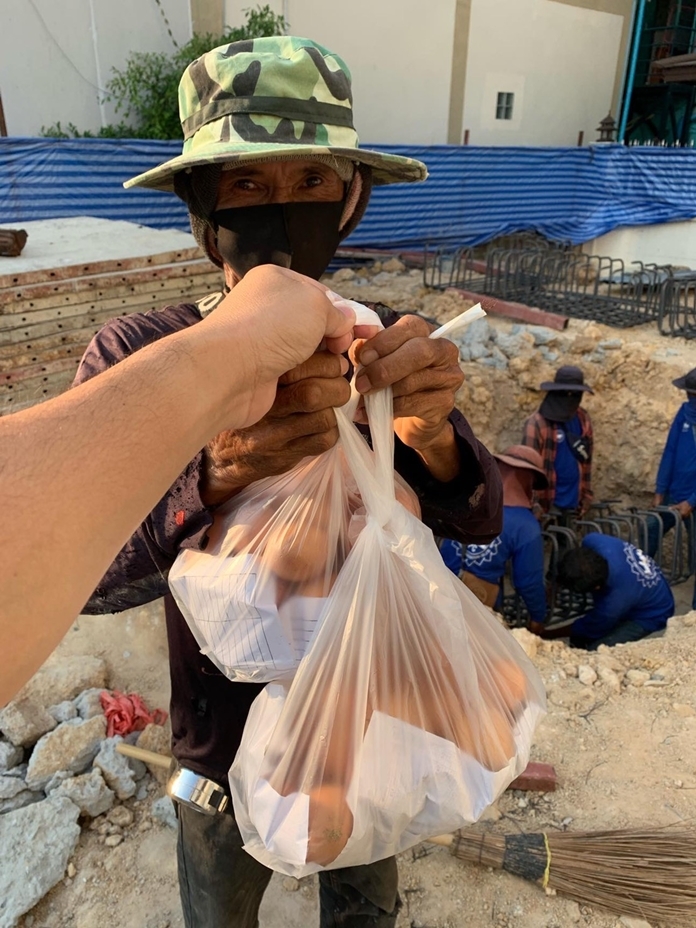 The expression on this man’s face says it all as he thankfully receives two bags of eggs.