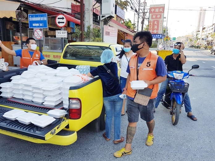 Yupin’s yellow truck is laden with food boxes for distribution to people in need.