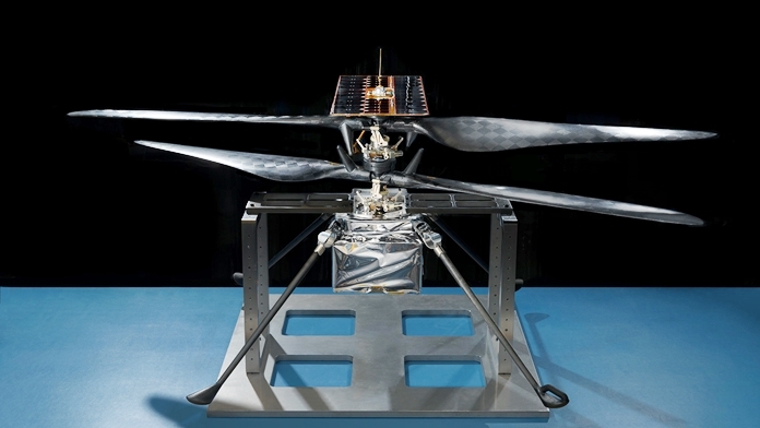 This image of the flight model of NASA’s Mars Helicopter was taken on Feb. 14, 2019, in a cleanroom at JPL. The aluminum base plate, side posts and crossbeam around the helicopter protect its landing legs and the attachment points that will hold it to the belly of the Mars 2020 rover. (Credits: NASA/JPL-Caltech)