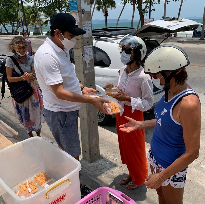 Food is handed out to the public on Pattaya Beach Road.