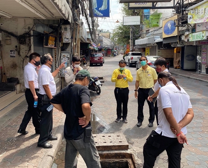 Deputy Mayor Pattana Boonsawad surveys the roadwork on the shuttered nightlife strip with city engineers and contractors.