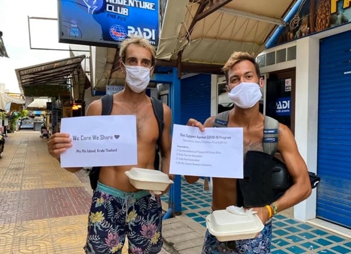 Tourists hold up signs of gratitude for the kindness and care that the receive from the Thai people.