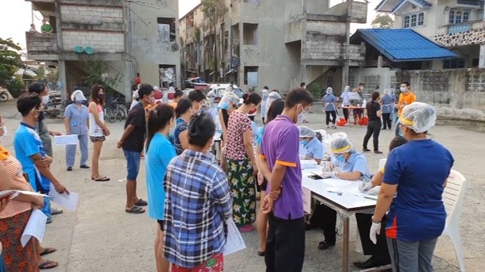 Thai health officials conduct a random testing of 2,100 migrant workers in Samut Sakhon province.