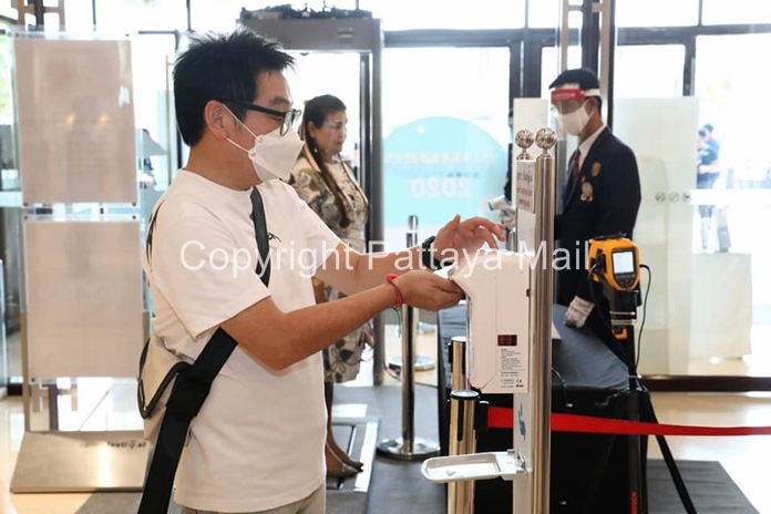 Shoppers must apply hand sanitizer and wear face masks.