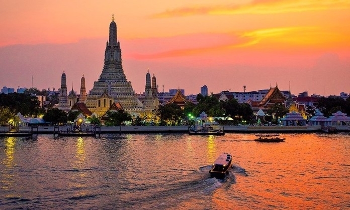 Wat Arun by the Chao Praya River, Bangkok at sunset.