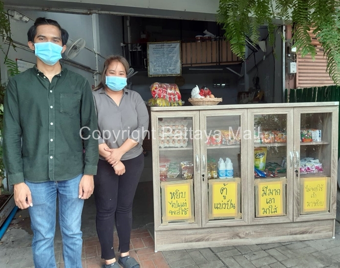 Sarunyu Cholhan and Sukanya Pimpakorn pose beside their Food Sharing Cupboard set up in front of their shop on Chaiyapornwithi Road.