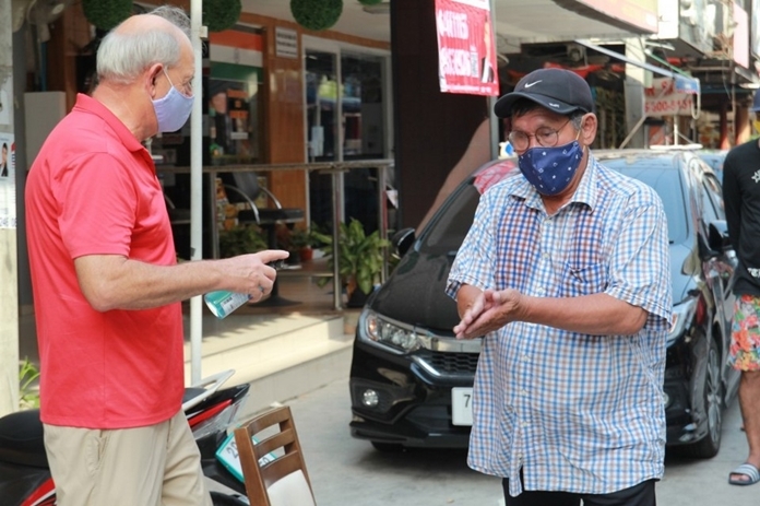 Everyone must wash their hands with sanitizing gel before receiving a food box.
