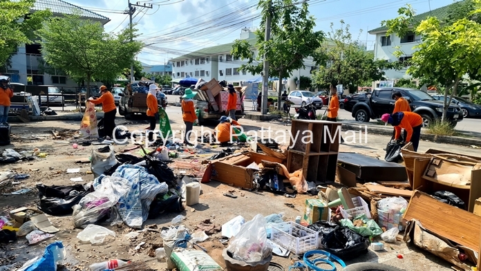 A squad of workers used equipment and trucks to remove garbage, broken appliances and furniture from 15 spots around the housing project.