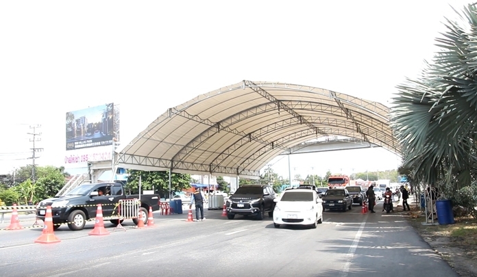 Pattaya checkpoint officials screen road users for their temperature and travel logs before the checkpoints were dismantled on Tuesday.