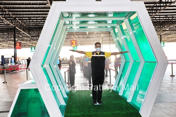 Sattahip District Chief Anucha Intasorn tries out the new disinfectant tunnel at Nong Nuch.