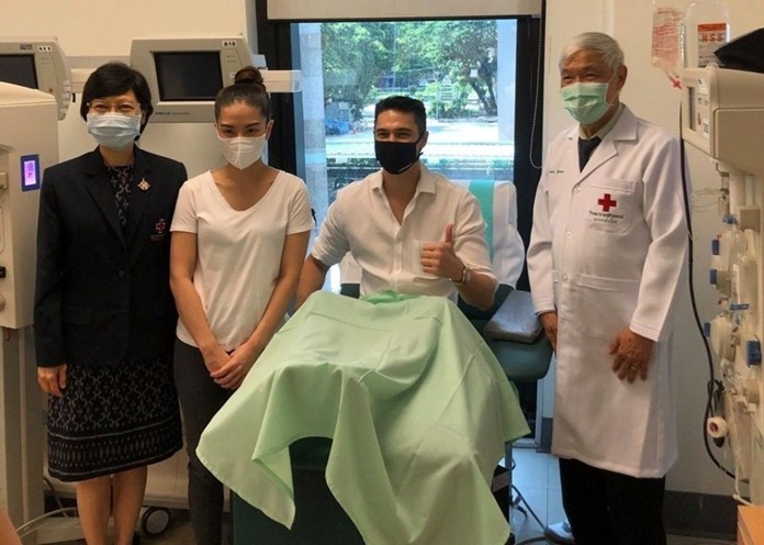 Matthew Deane, in the chair, a TV host and movie star donates plasma to help other COVID-19 patients.