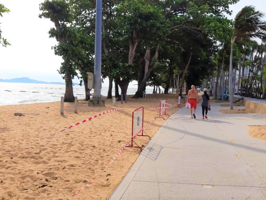 Jomtien Beach on a sunny day under restrictions from the Pattaya City Hall on temporary closing of all the beaches. Visitors can only use the footpath for walking and individual activities. 