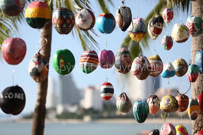 Finished artwork is hung up like wind chimes.