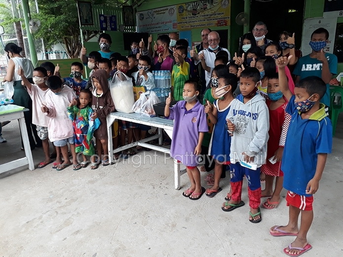 Khru Ja, Stan Rees, Nigel Cannon and Tim Knight are surrounded by the children happy with their new printer.