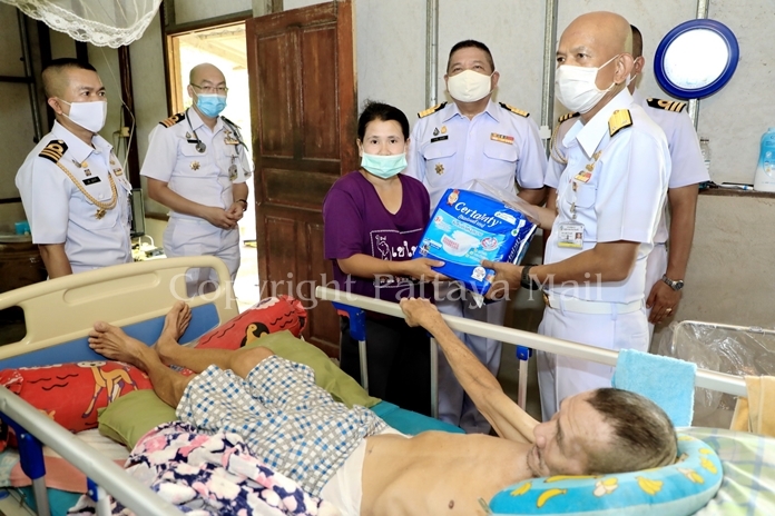 Rear Adm. Utai Chewasutti, navy medics and enlisted men visited Prasert Lim, 75, at his home in Ban Chang’s Cheung Khao Community