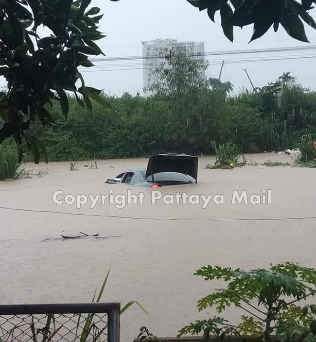 The flood on the Railway Road was high enough to wash a Mercedes sedan into a ditch, requiring volunteers to rescue two mothers and their children.