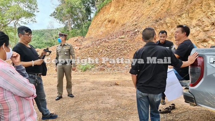 Surathep Topanitch (seated on tailgate) and his brother filed trespassing charges against forestry officials he claimed came armed to his property for an illegal inspection.