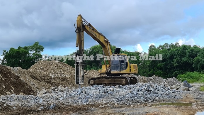 The rock crusher at work unconcerned for the heavy damage it was causing to the neighboring temple.