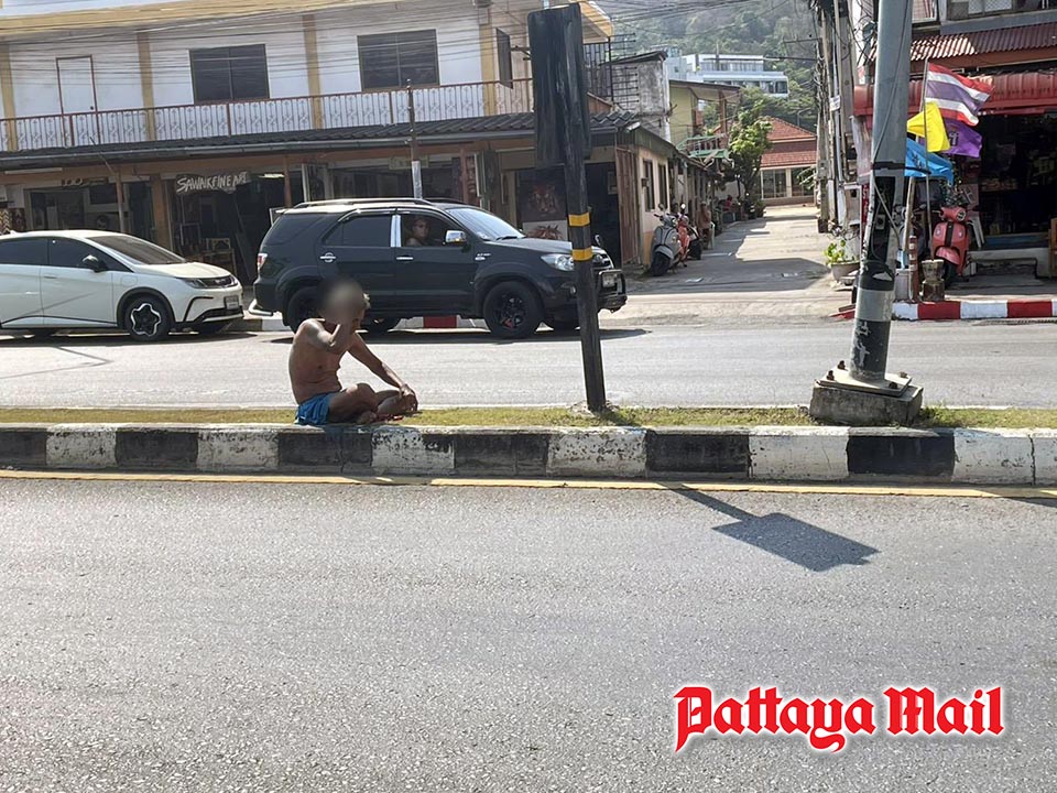 Not a place to relax as Pattaya officers move man from traffic island to safety