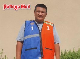 Pattaya motorcycle taxi rider zips orange and blue vests together in colorful compromise