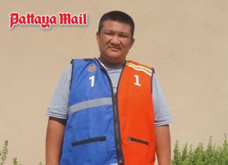 Pattaya motorcycle taxi rider zips orange and blue vests together in colorful compromise