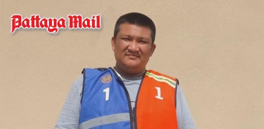 Pattaya motorcycle taxi rider zips orange and blue vests together in colorful compromise