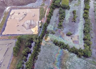 Oil-like sheen found in floodwater near industrial waste landfill in Prachin Buri